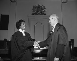 Violet King Henry shakes hands with senior partner at her 1954 bar call.