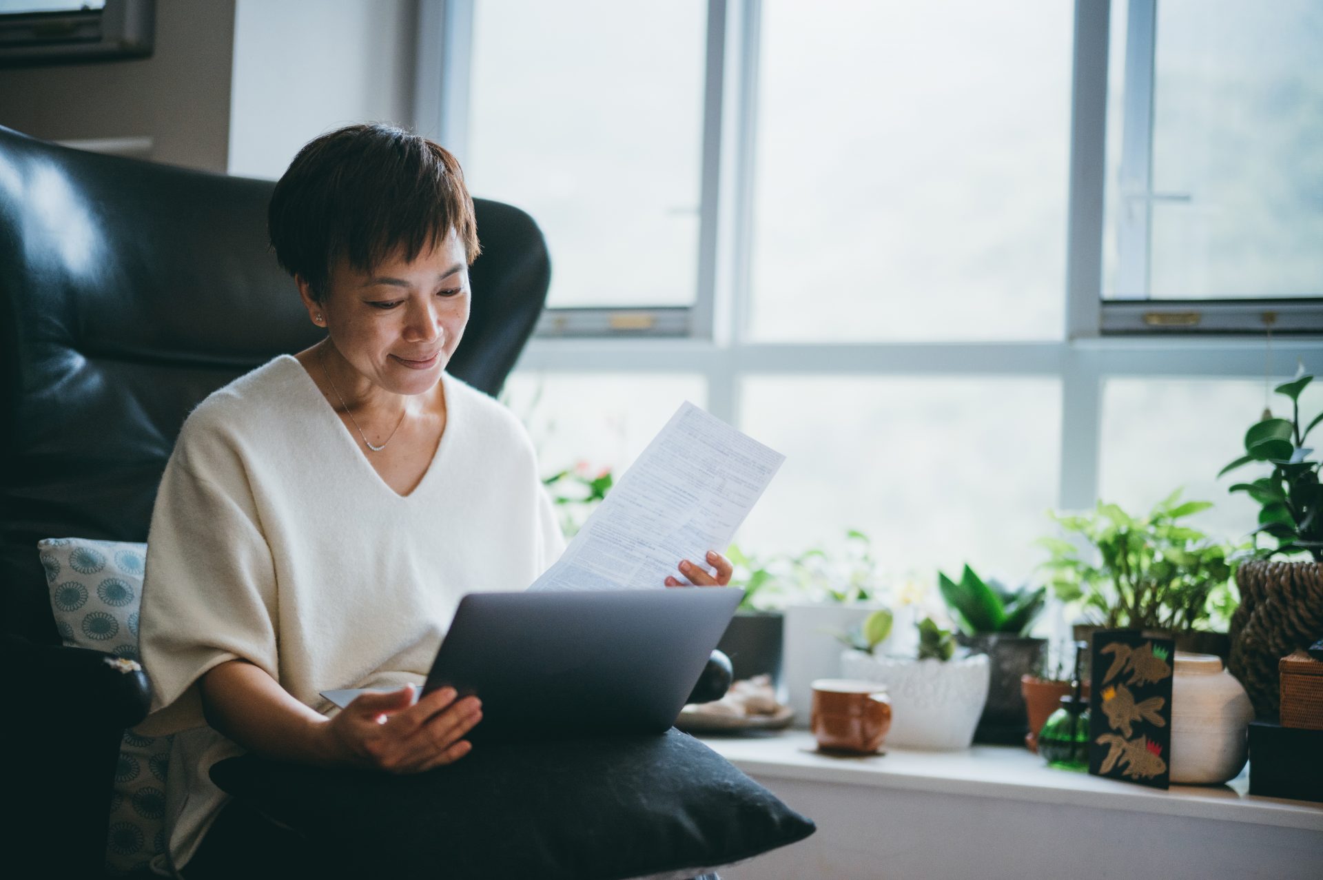 Middle aged woman looking at retirement planning documents